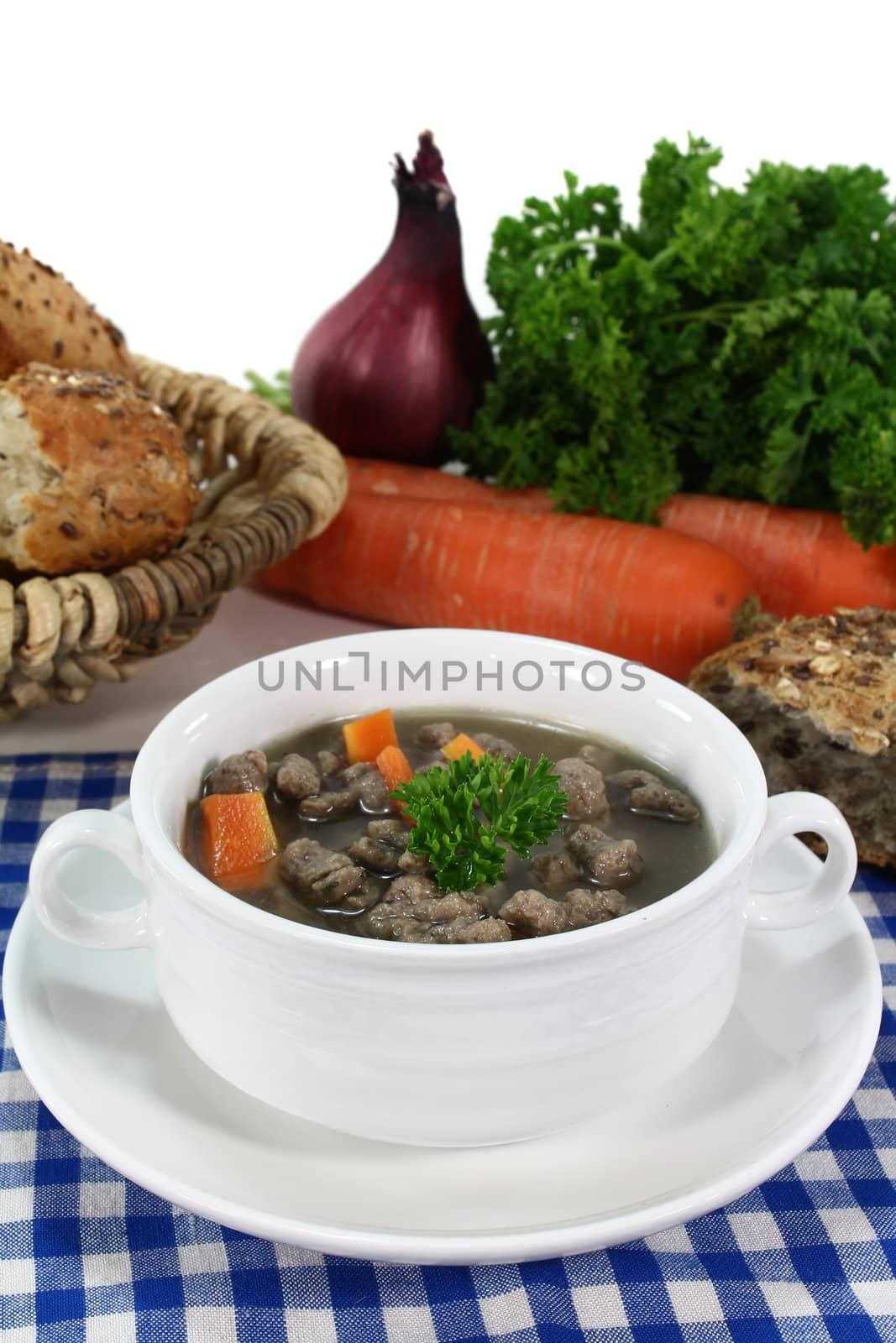 Liver noodles soup with vegetables and parsley in a soup cup