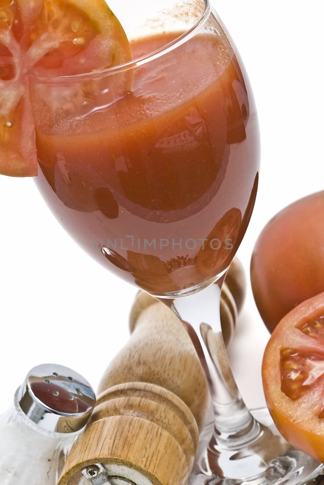 A cup of tomato juice on a white background.