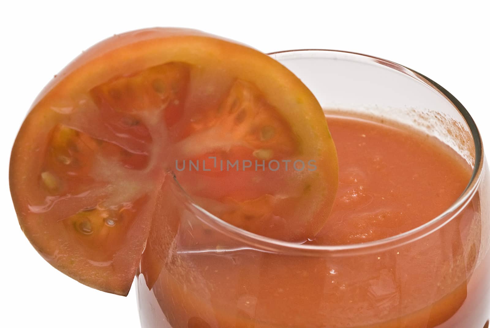 A cup of tomato juice on a white background.