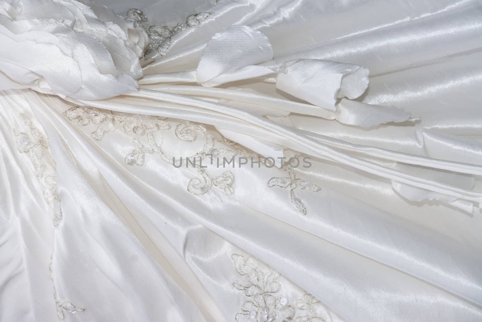embroidered white wedding dress close up background by paddythegolfer