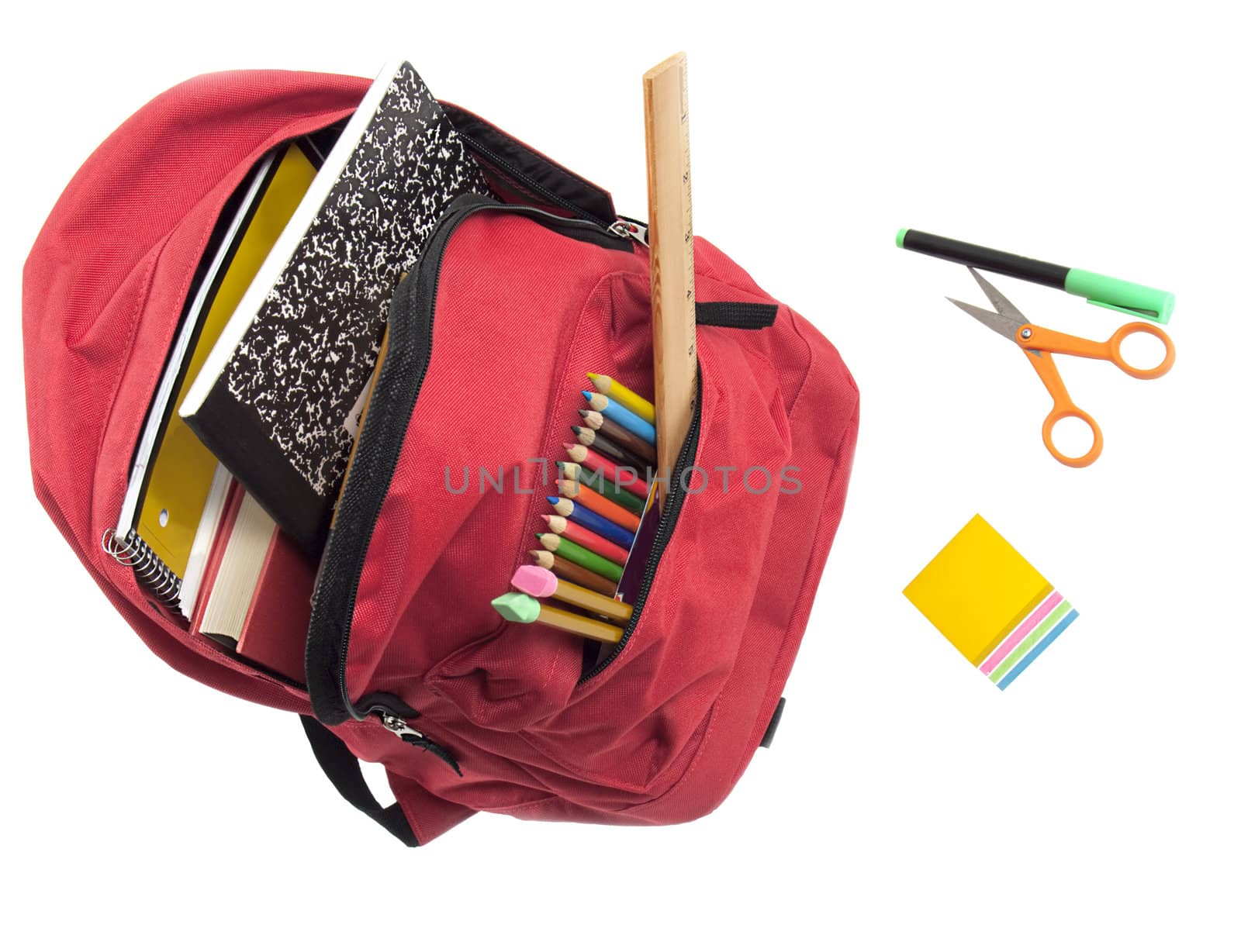 Bright red nylon backpack full of books, colored pencils, and with felt marker, sticky notes and scissors in front. All isolted on white for easy removal.
