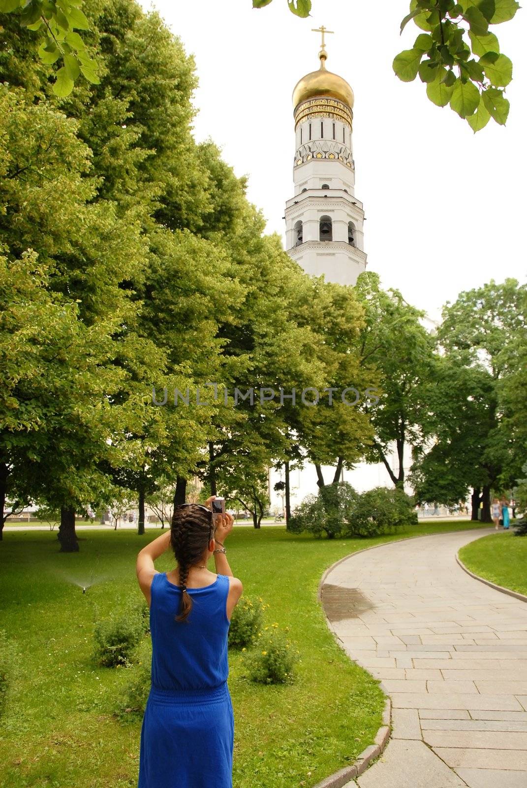 The Ivan the Great Bell Tower in Moscow Kremlin, girl tourist taking photo