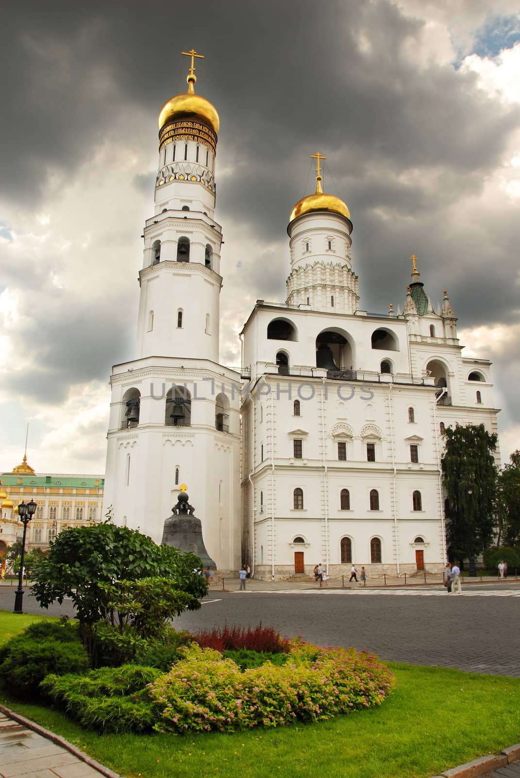 The Ivan the Great Bell Tower and Assumption Belfry in Moscow Kremlin over dramatic cloudy sky