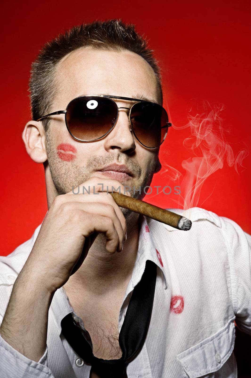 young handsome man with lips imprint smoking cigaro