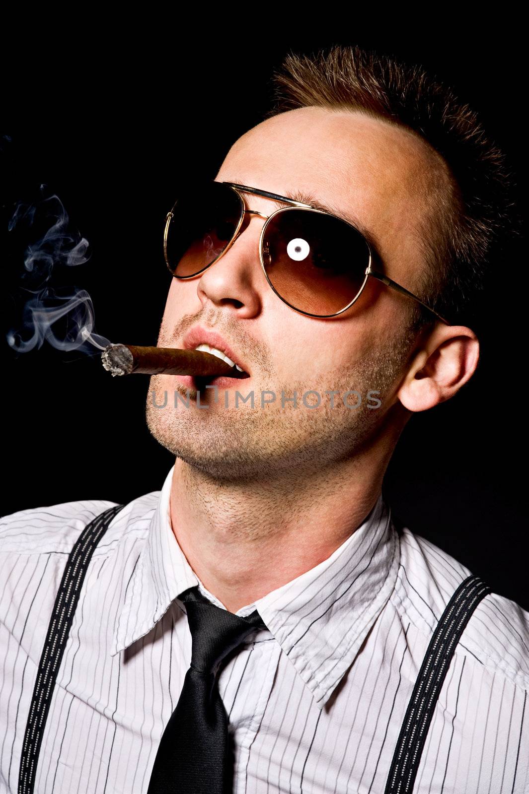 young confident man smoking cigar