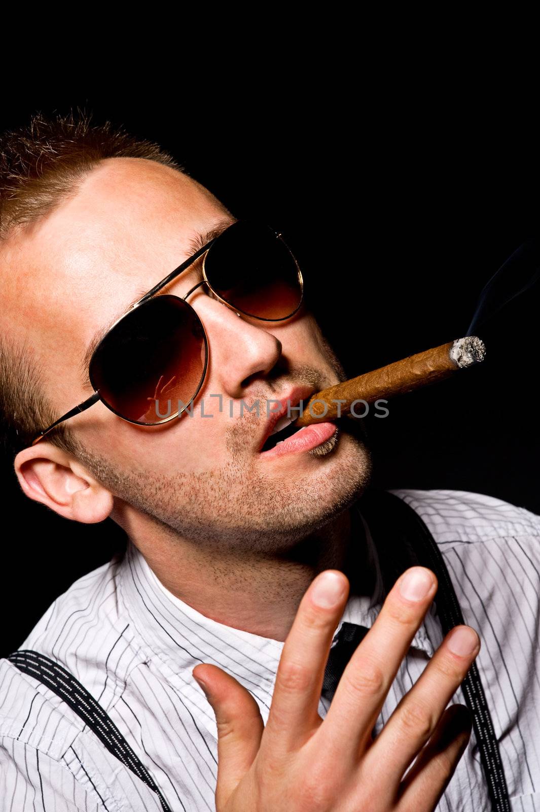 young handsome man smoking cigar