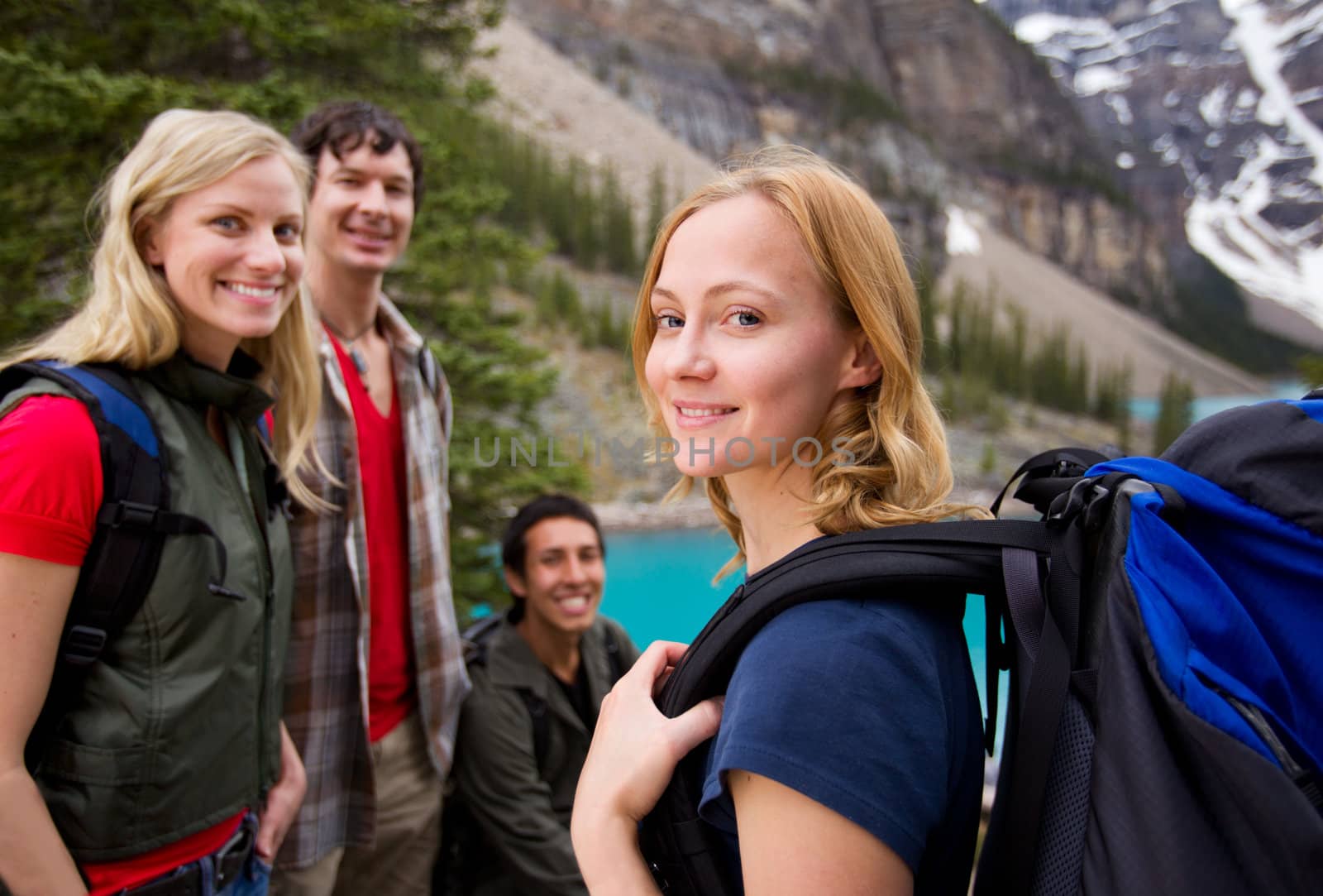 A group of friends hiking with a mountain landscape in the background