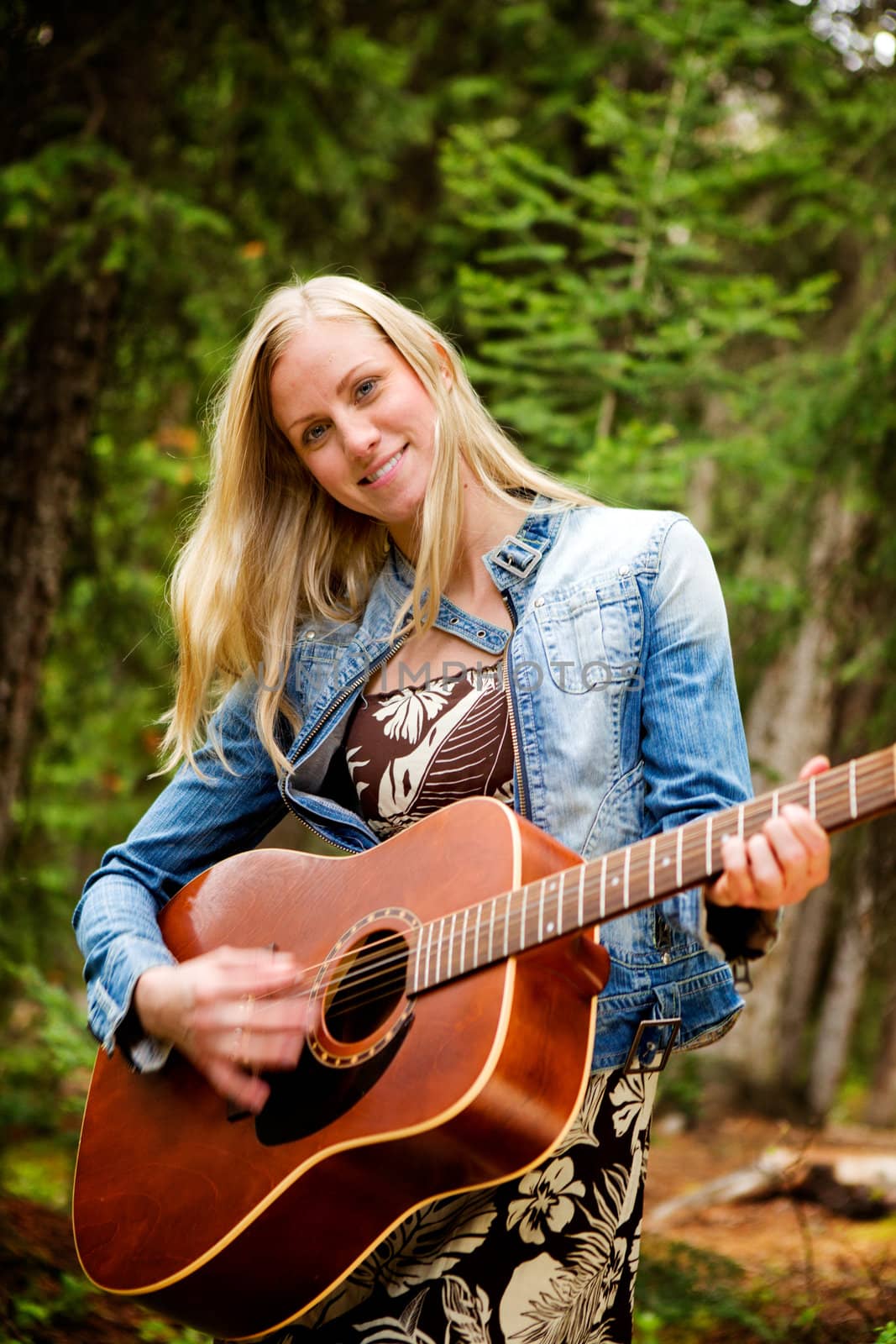 A happy pretty woman with a guitar