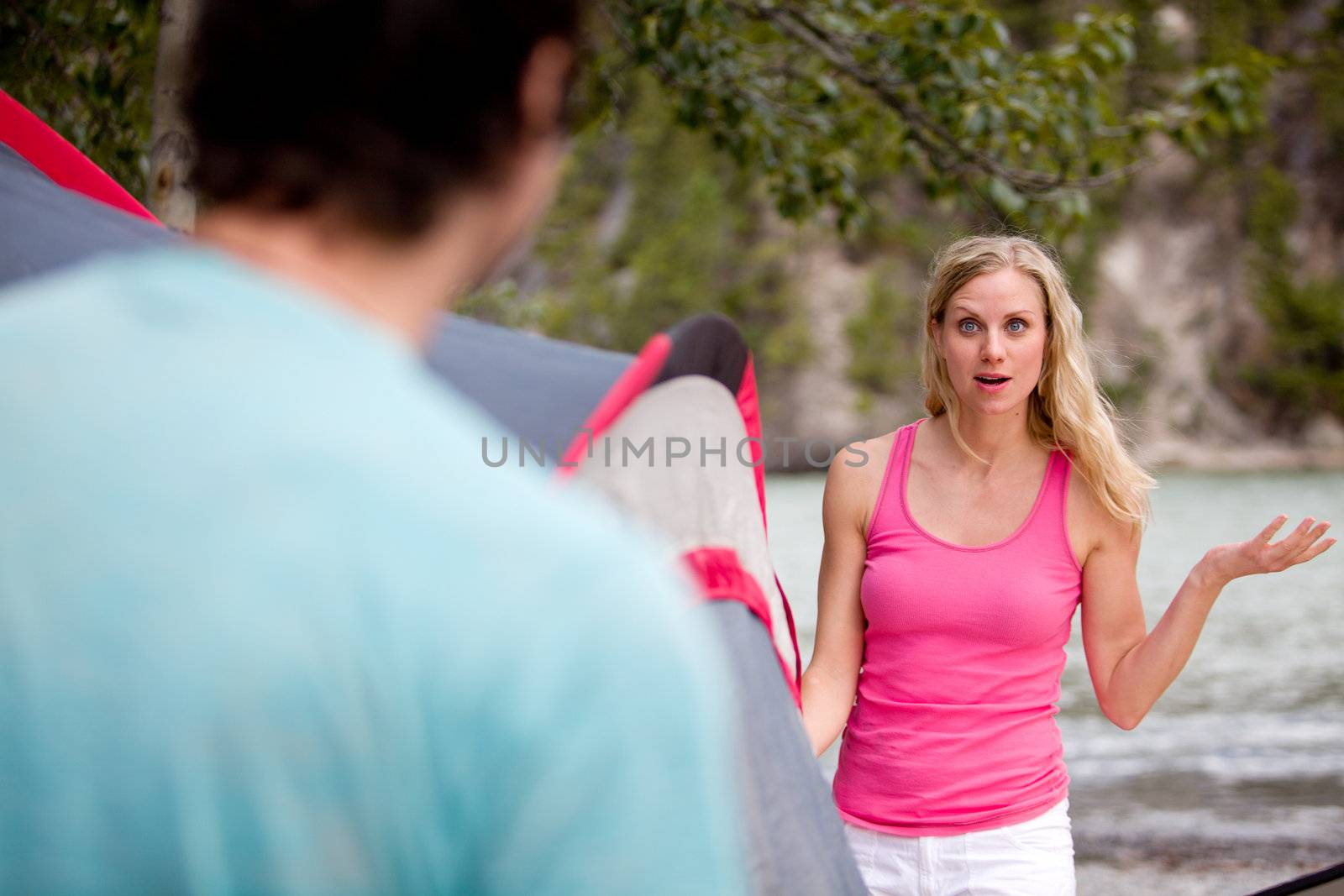 A couple arguing while setting up a sent