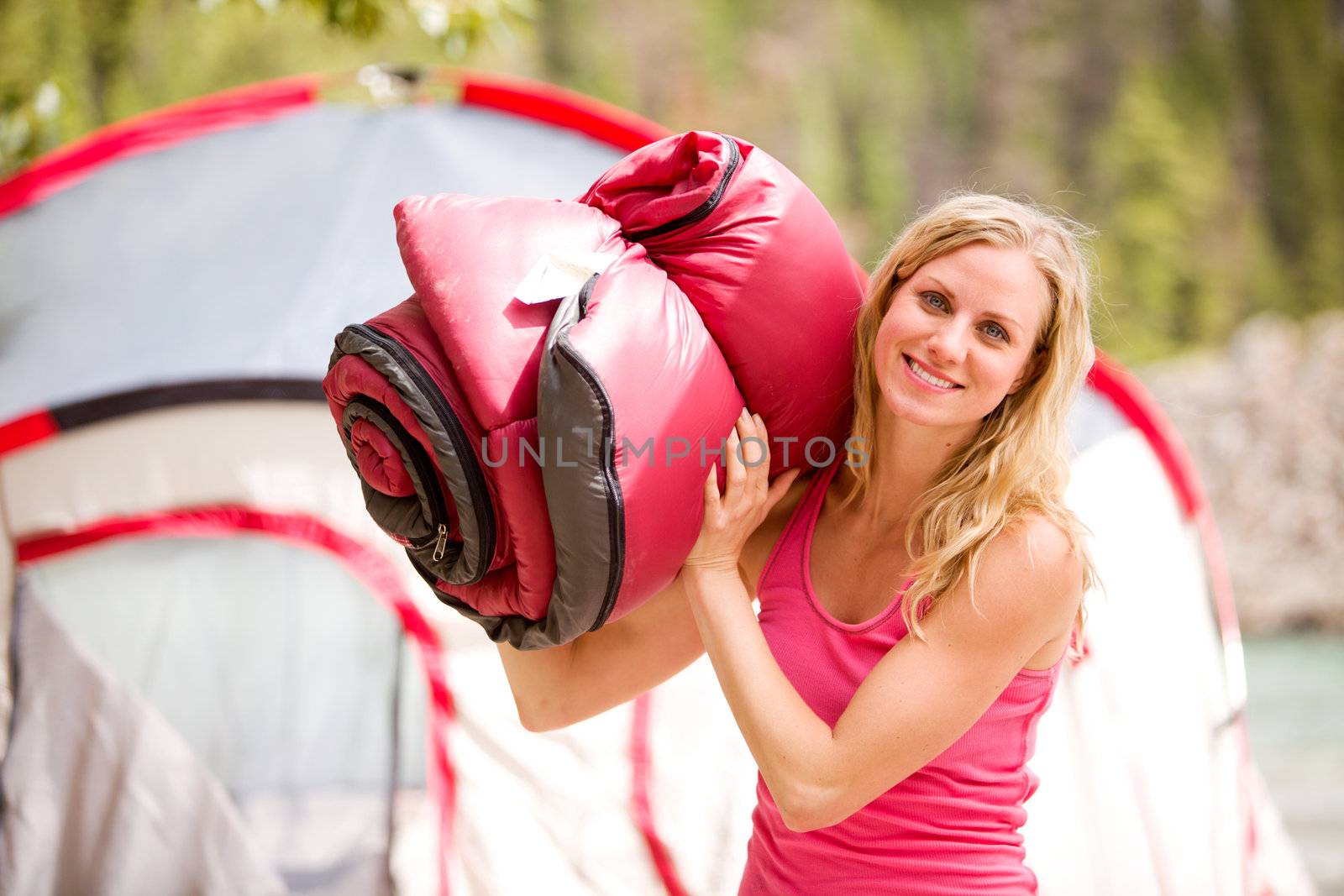 A portrait of a woman holding a sleeping bag