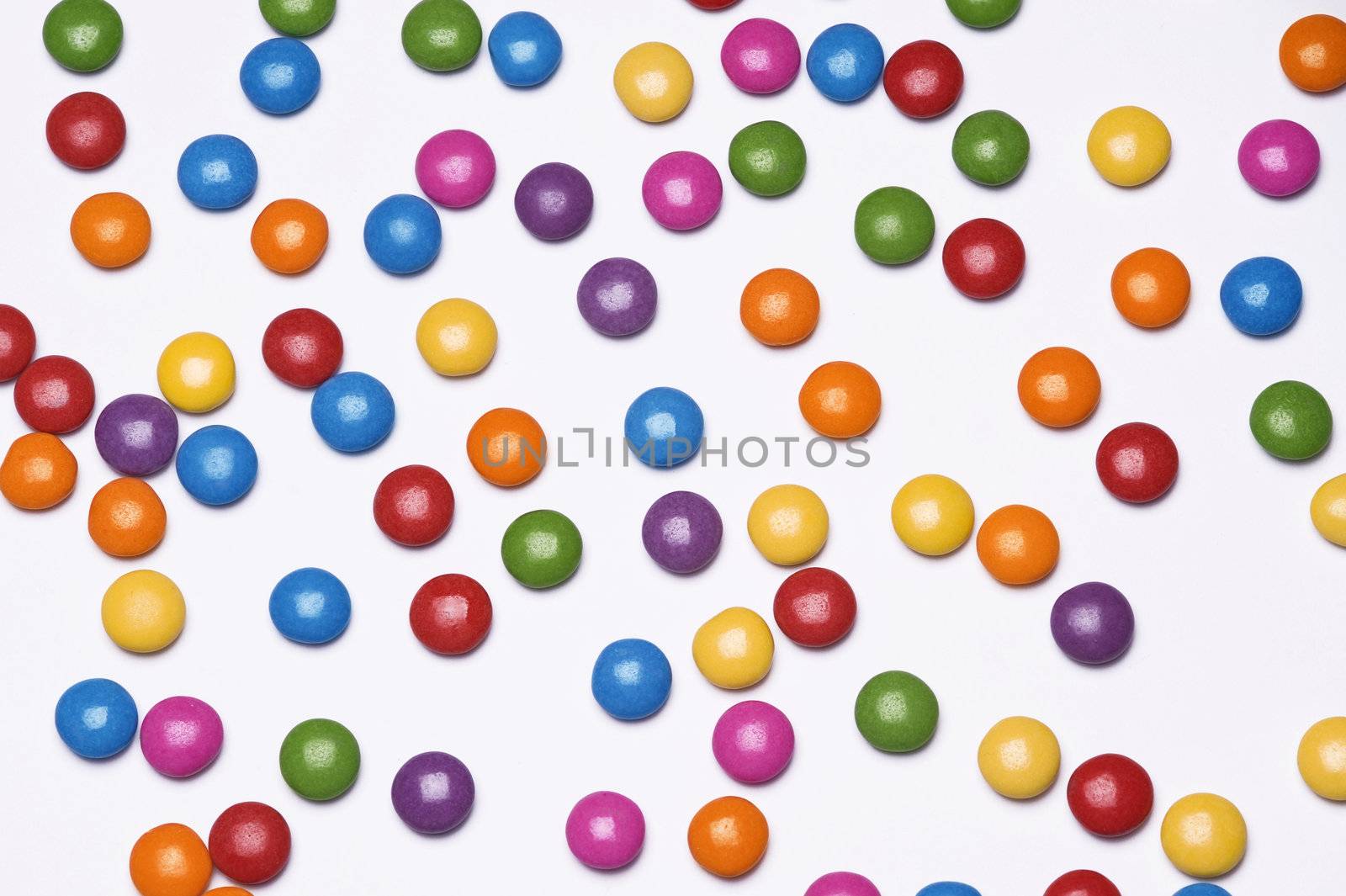 colorful pills scattered on white background