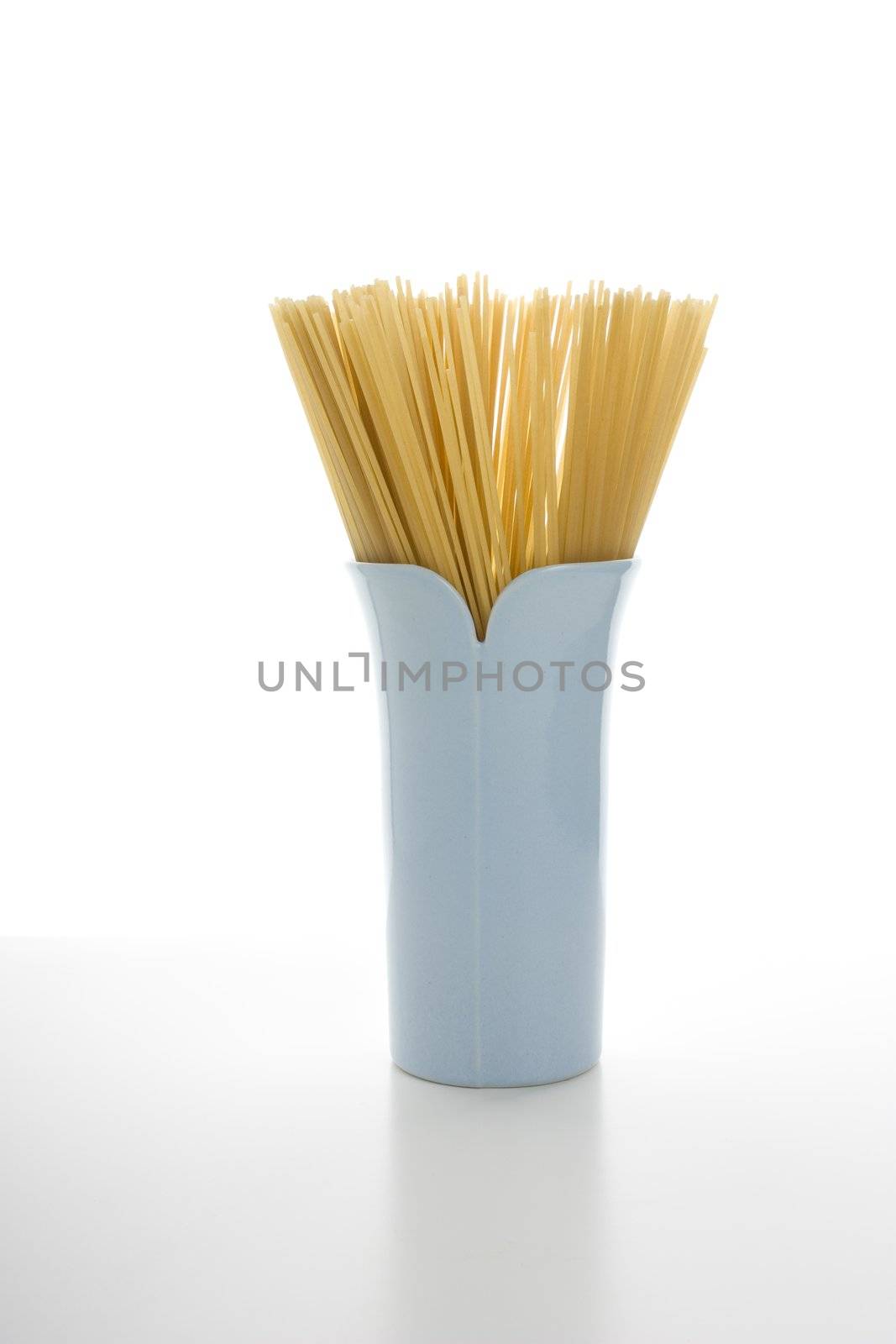 Spaghetti in blue vase with white background