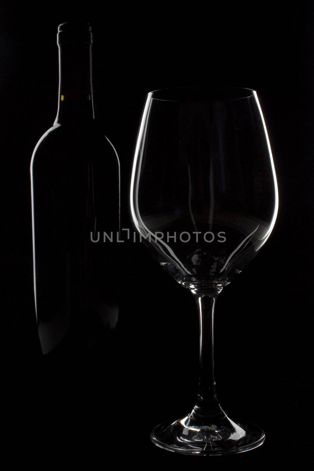 Outlines of wine bottle and wine glass on black