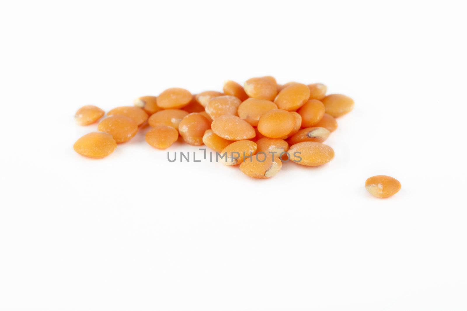 Group of red lentils on white background