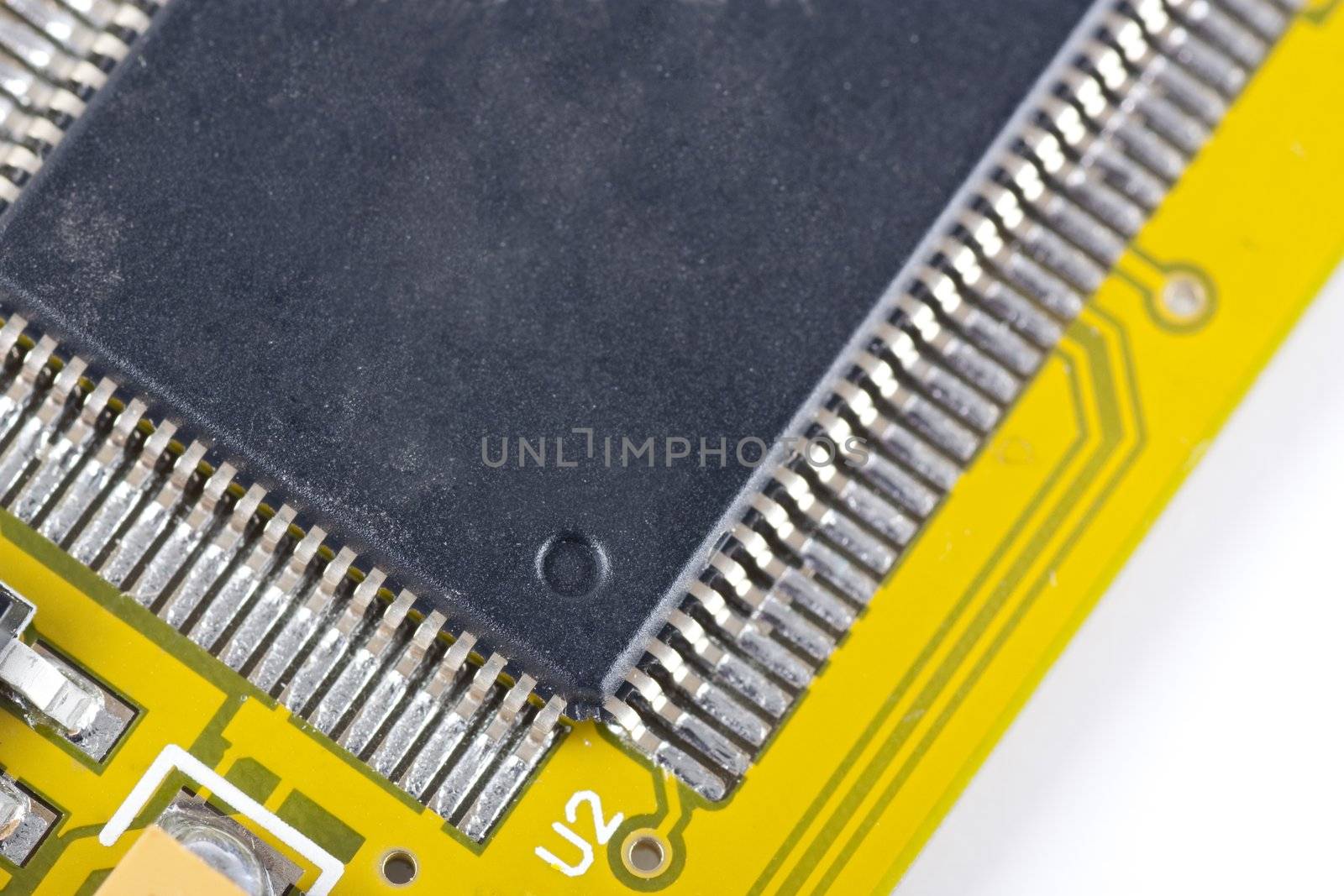 Close up of yellow circuit board with micro chip.  