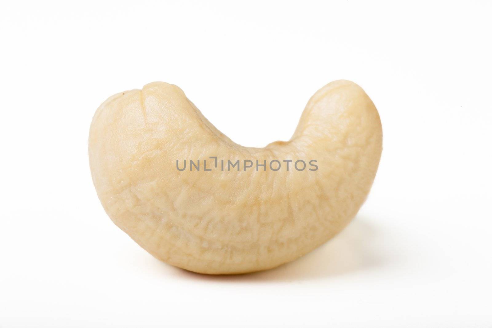 Single cashew nut isolated on white background.