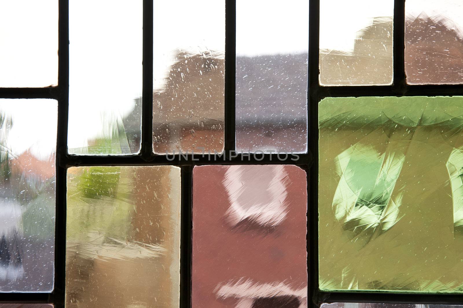 Abstract distortion of buildings through leaded glass.