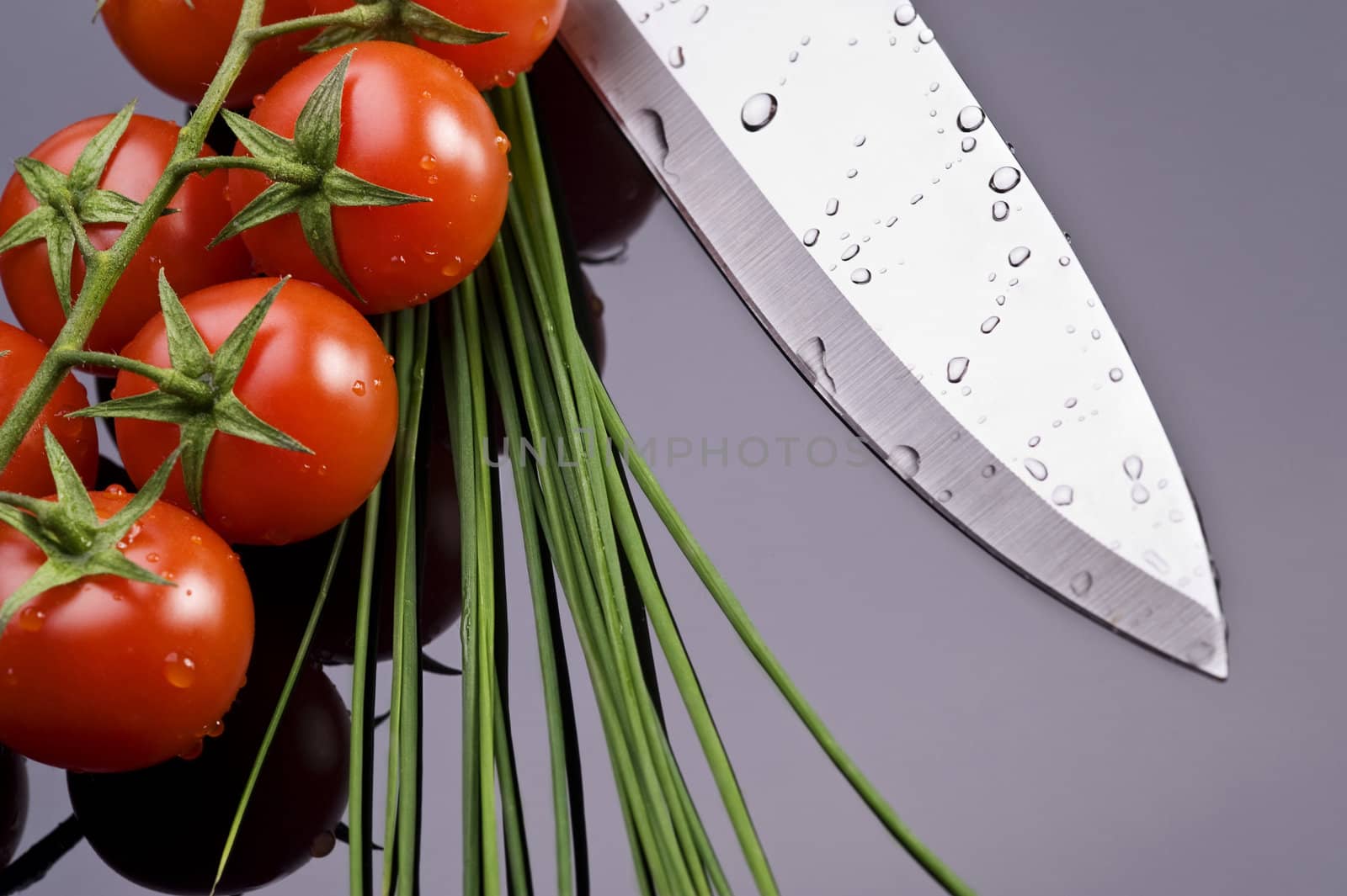 fresh wet tomatoes chive and knife