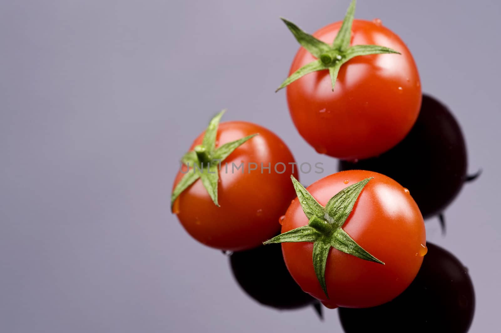 fresh three tomatoes on the black table