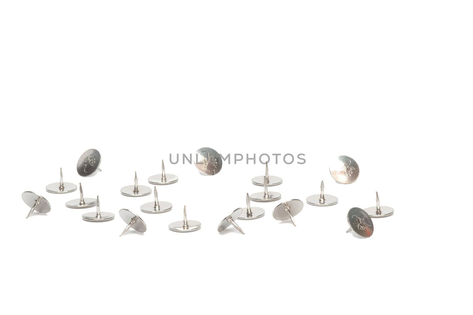 Metal tacks scattered isolated on white