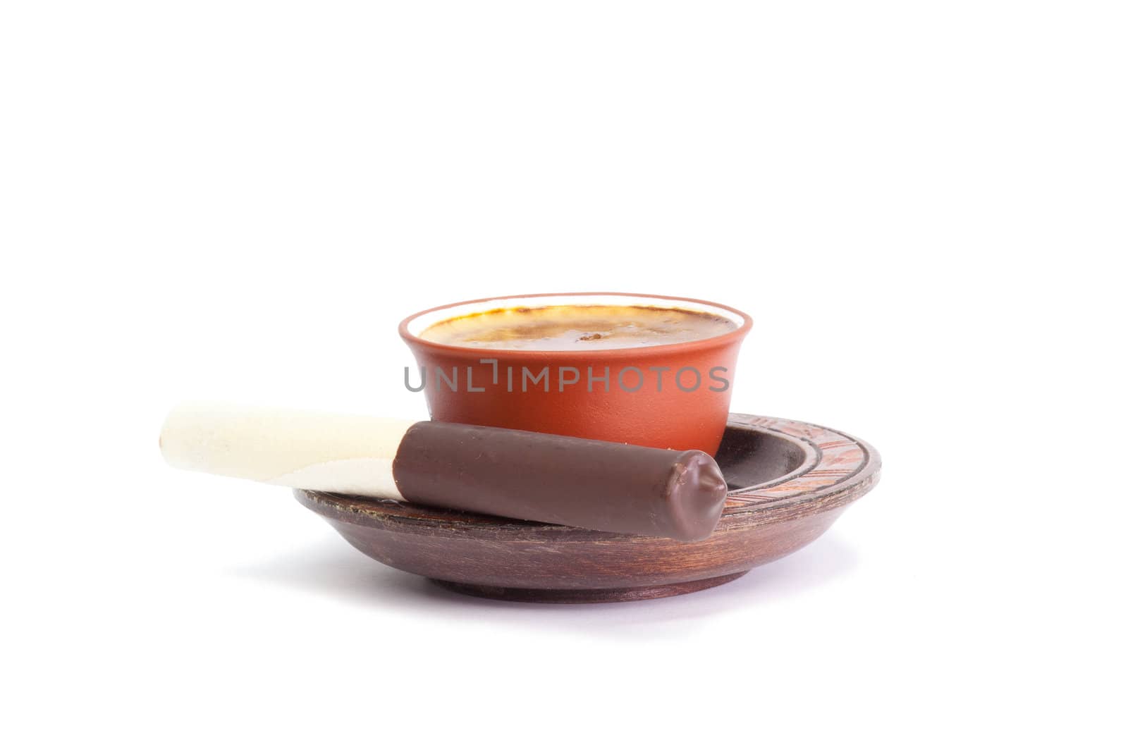 Coffee and chocolate tube on a wooden saucer