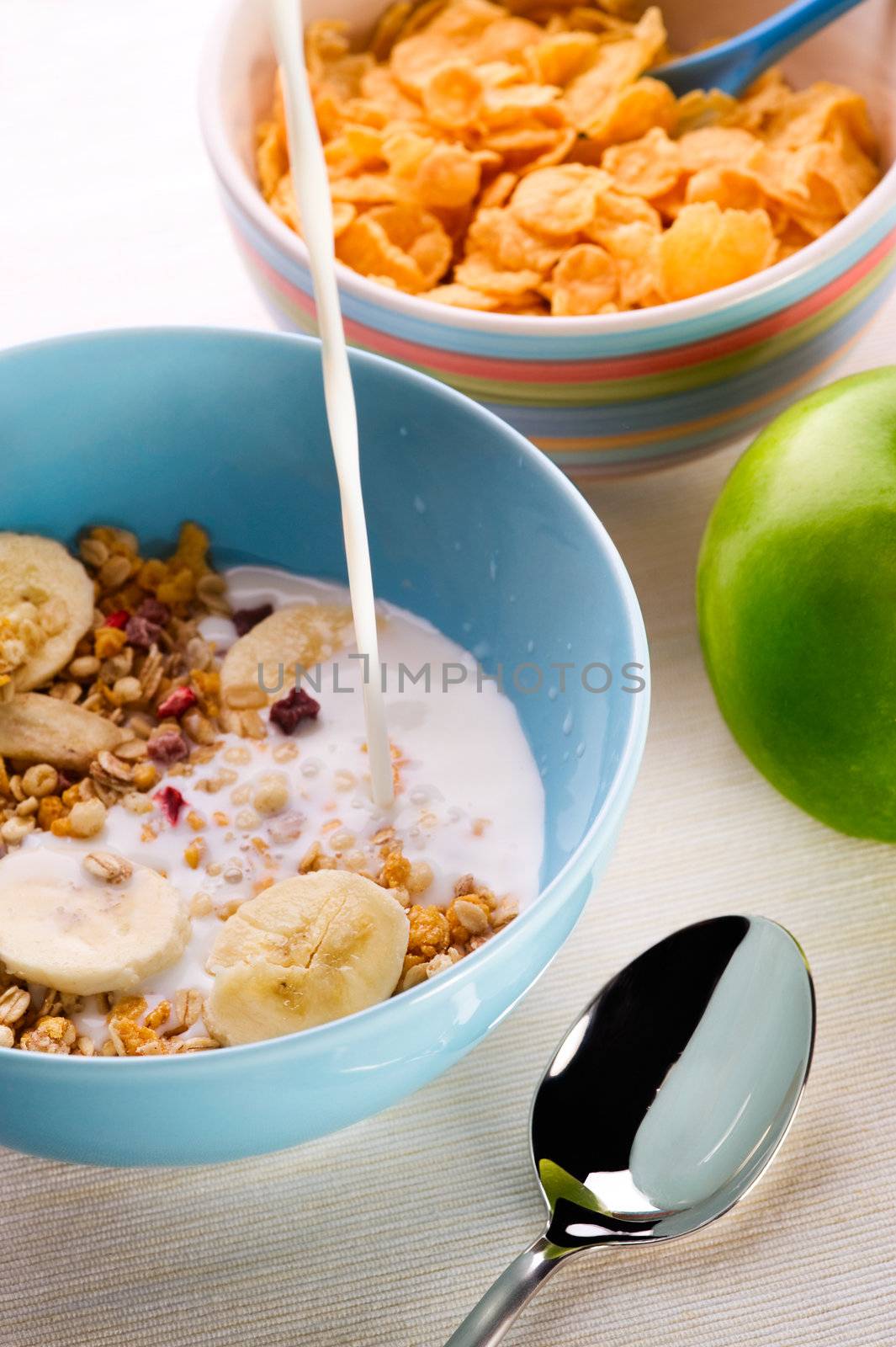 healthy breakfast of muesli, fruit and milk on the table