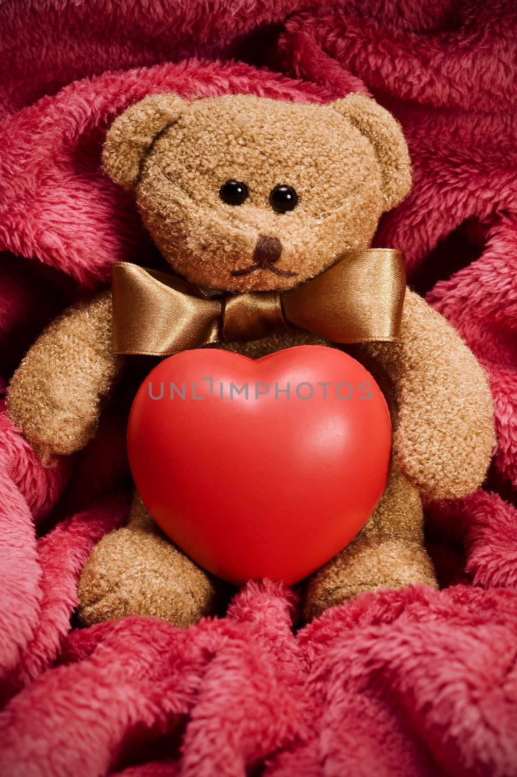 valentines teddy bear with bow holding heart
