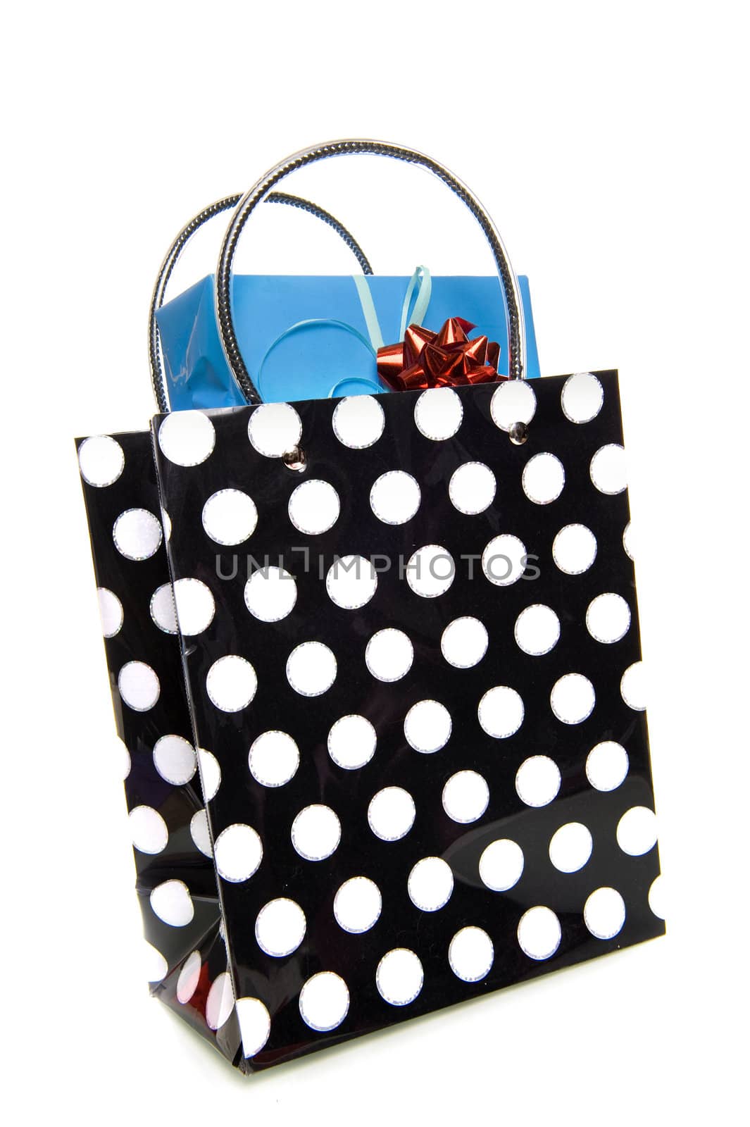 a dotted black and white bag with a blue present on a white background
