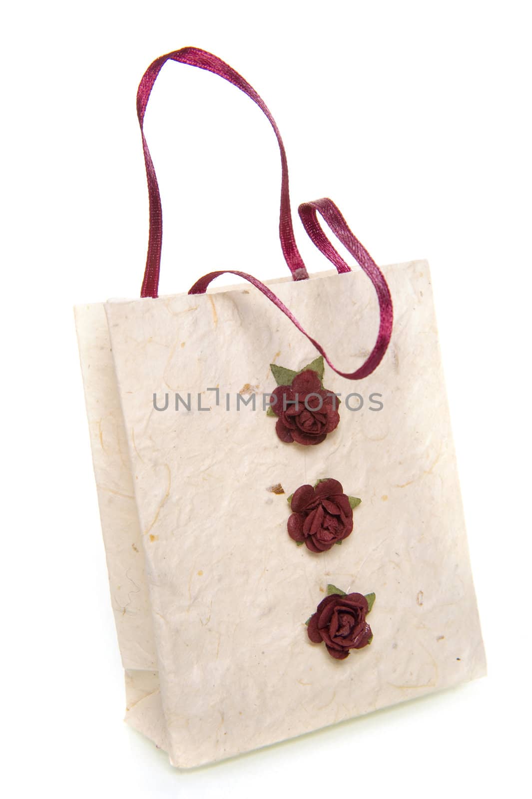 a handmade white bag with three little red roses on a white background