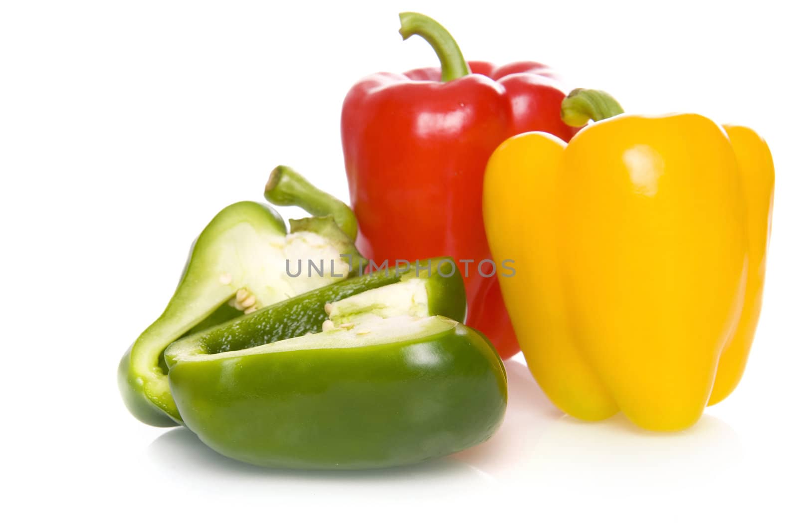 three fresh and healthy paprikas on a white background