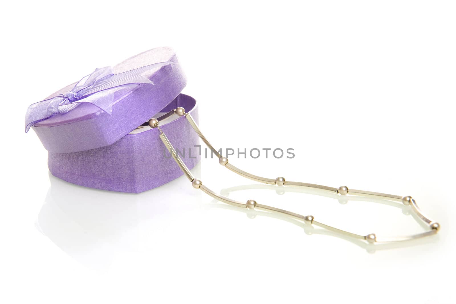 a purple heart box with jewellery on a white background