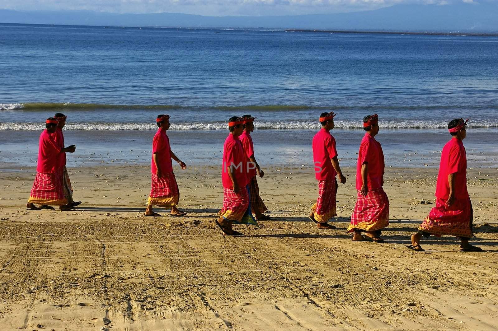 Balinese Hindu men on the beach by Komar