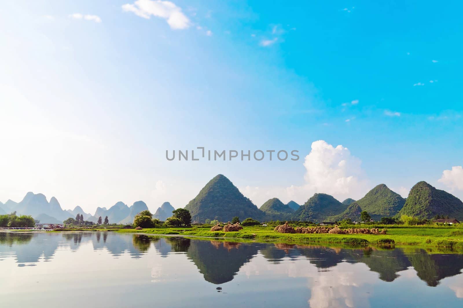 Reflection of the muntains in Li River landscape in morning light, Yangshuo near Guilin,