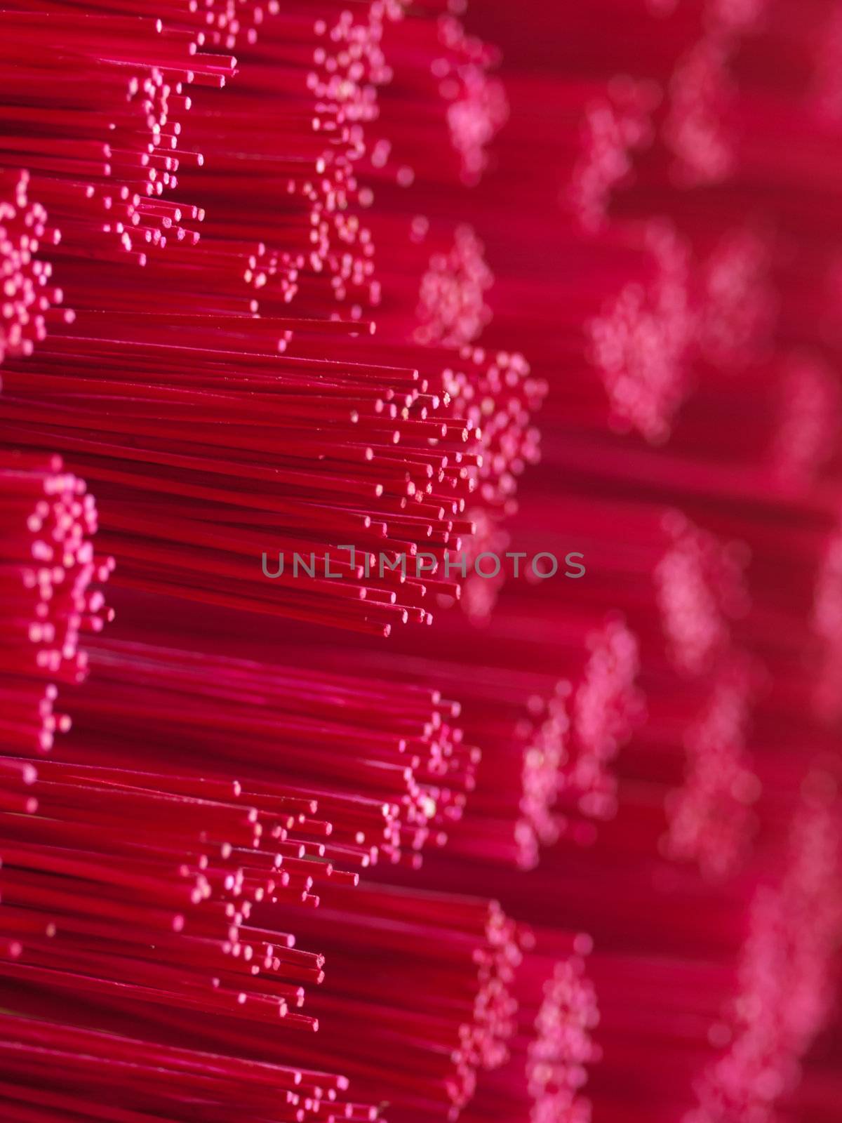 Closeup of a pile of pink joss stick in a buddhist temple
