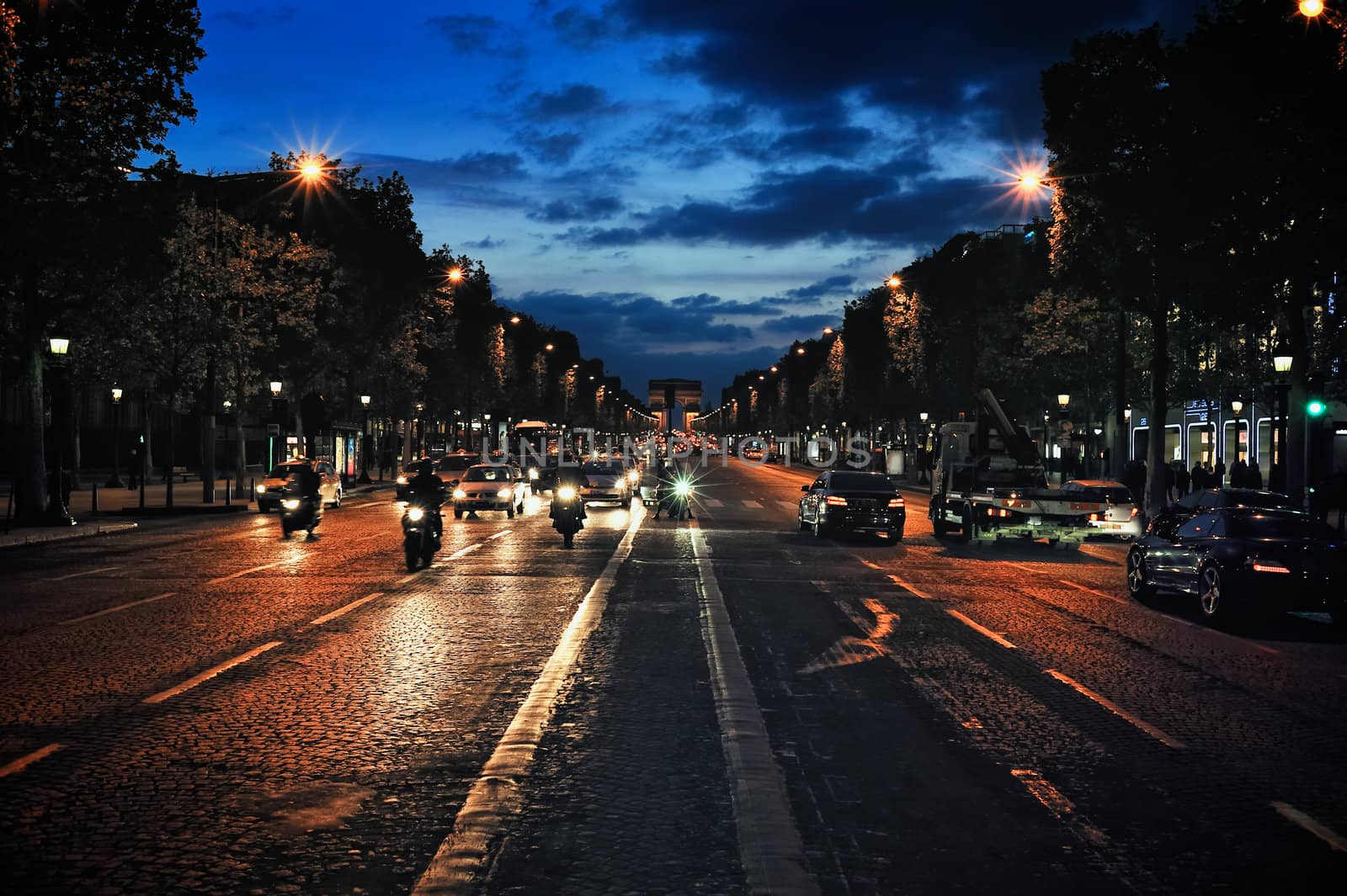 Traffic on the avenue Champs-Elysees at evening