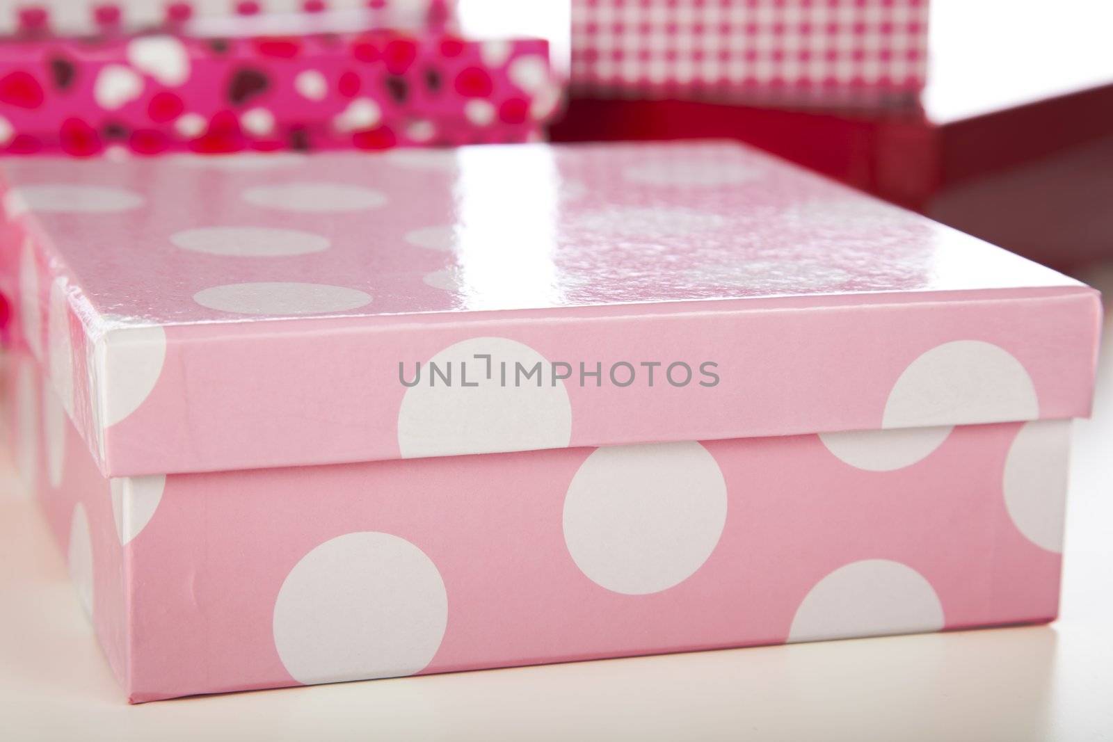 Decorative pink and while polka dot gift box closeup.