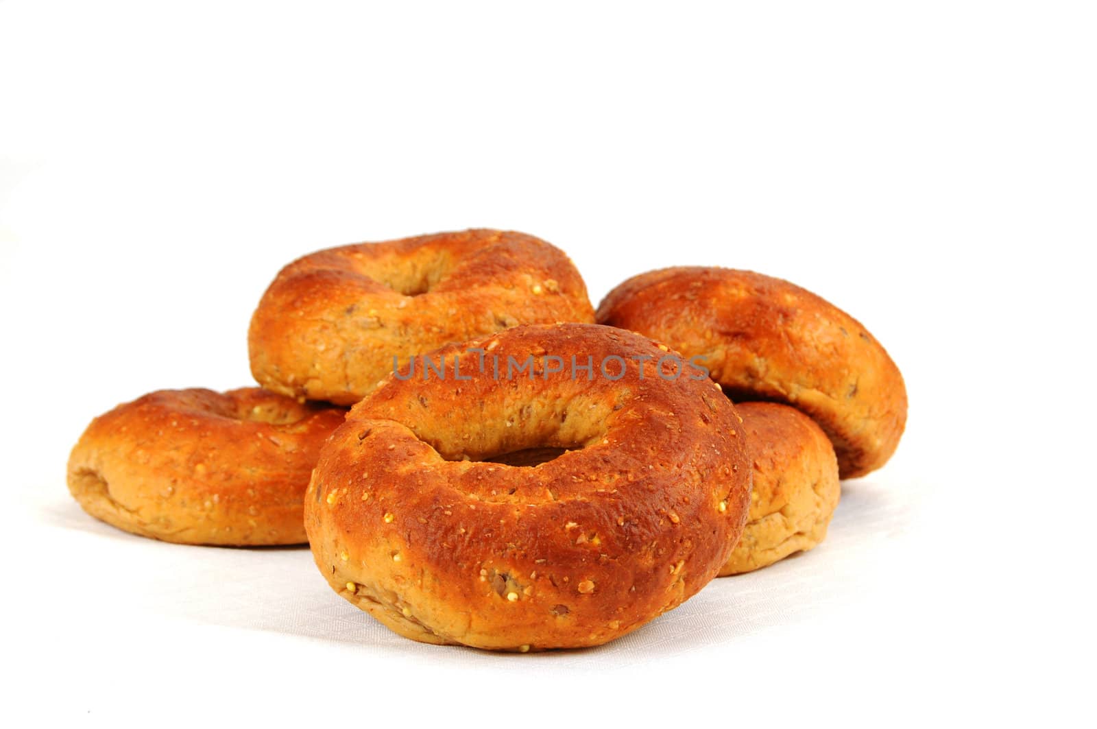 Fresh multigrain bagels shot on a white background.