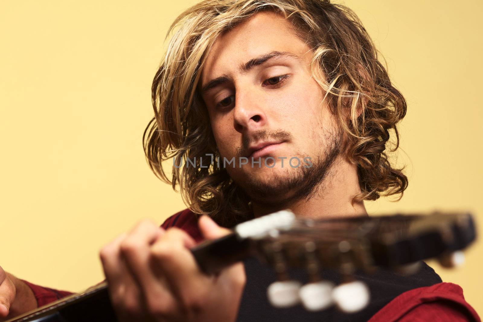 Young Man Playing the Guitar by ildi