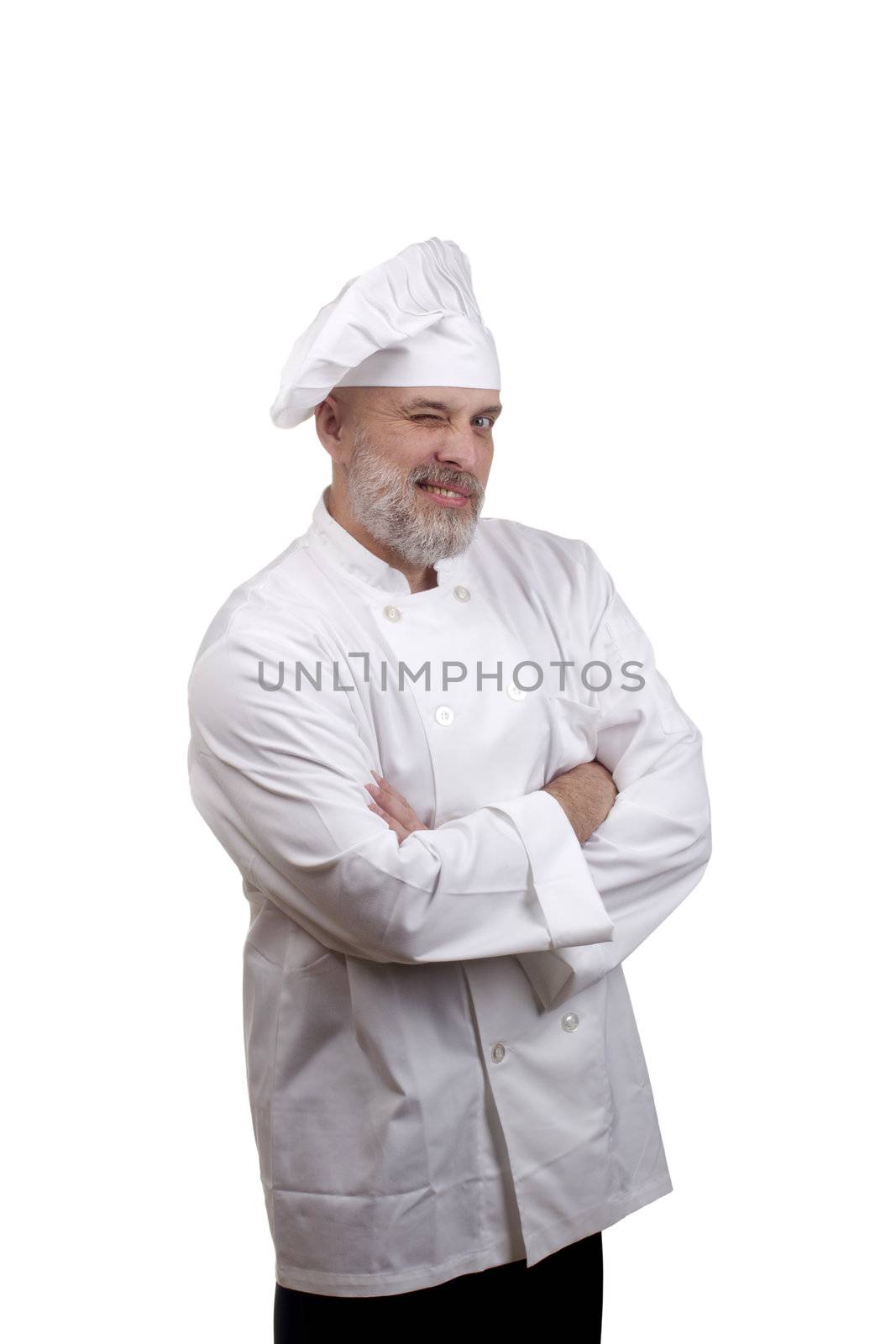 Portrait of a happy chef winking in a chef's hat and uniform isolated on a white background.