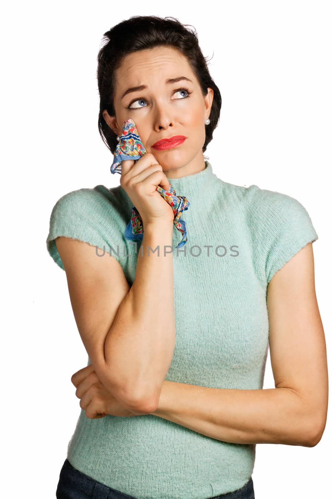 Beautiful young woman wiping tears with handkerchief. 1950's look isolated over white.