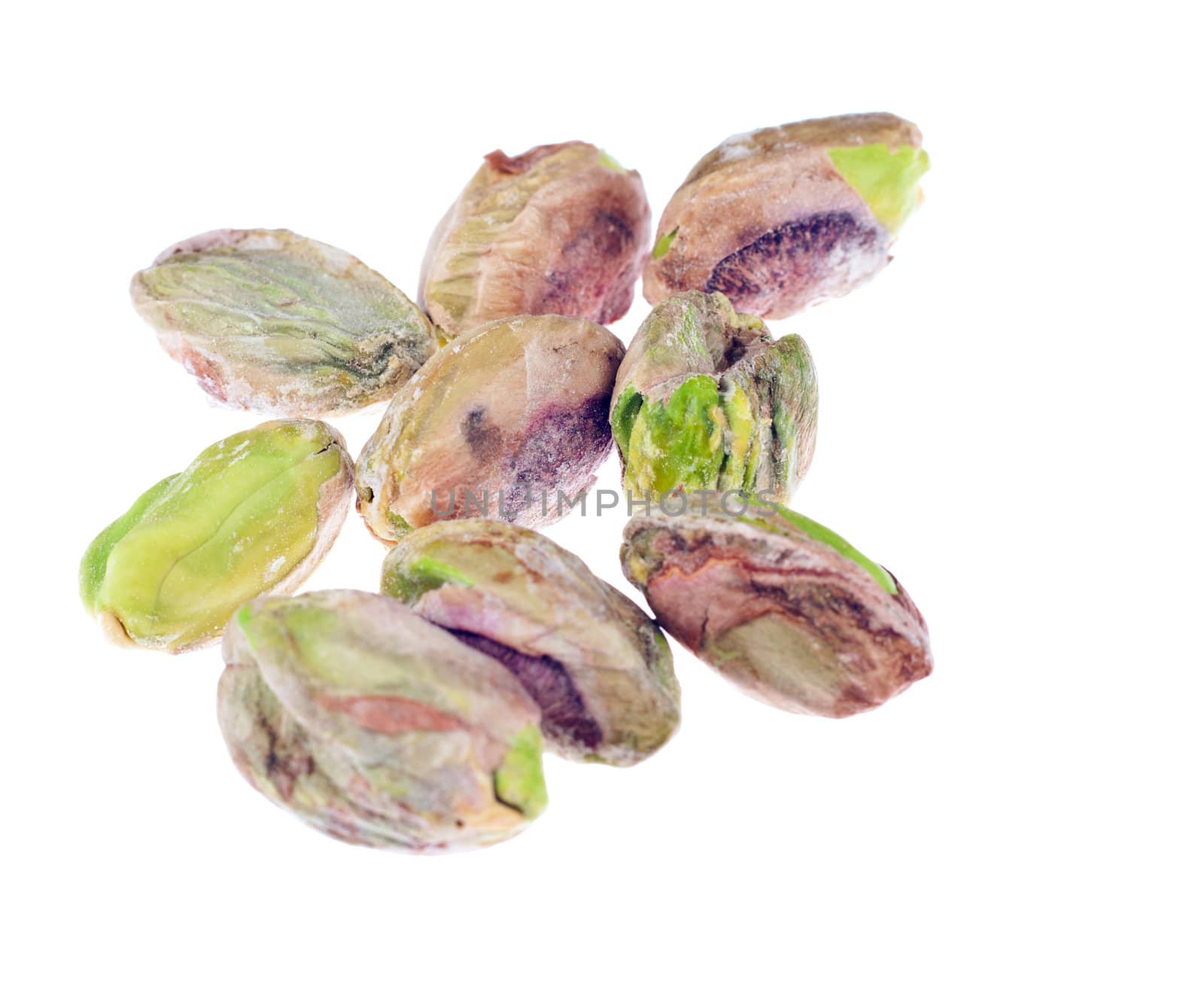 A closeup shot of a bunch of peeled Pistachio nuts. Isolated over white. 