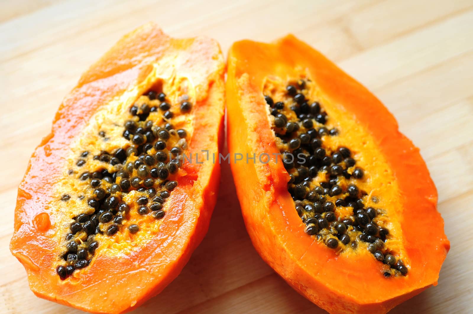 Fresh ripe papaya fruit cut into halves