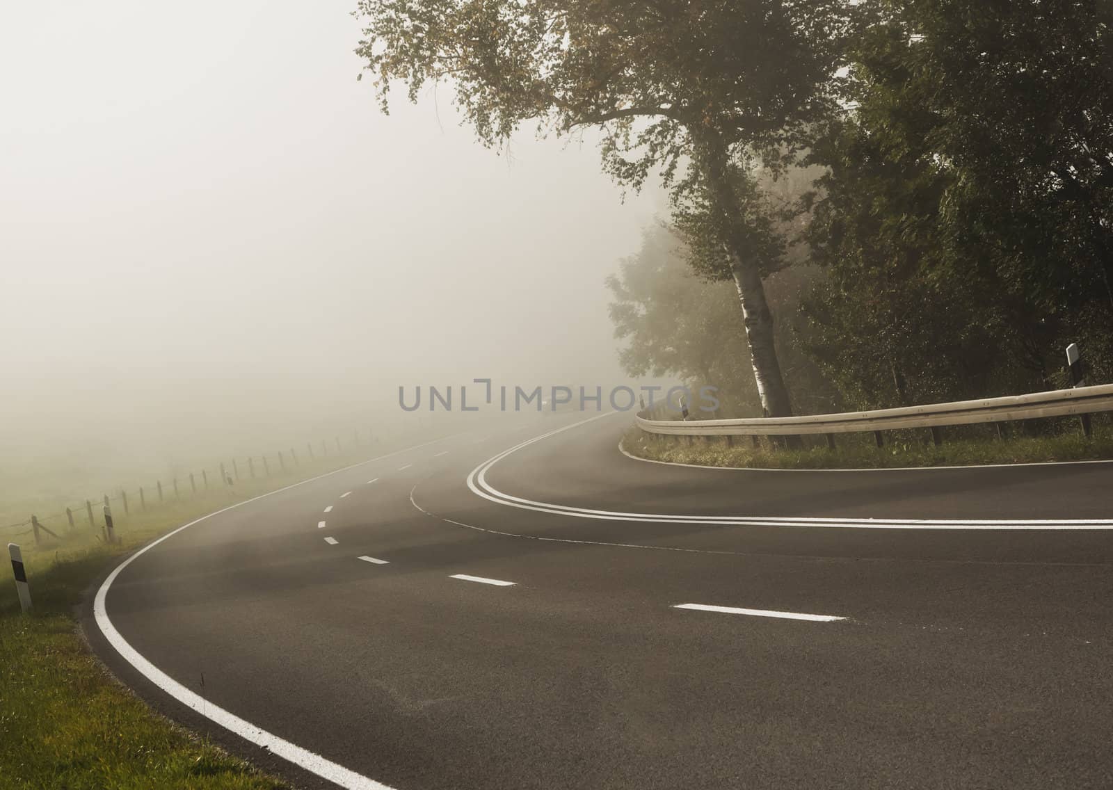 An image of a road covered in fog