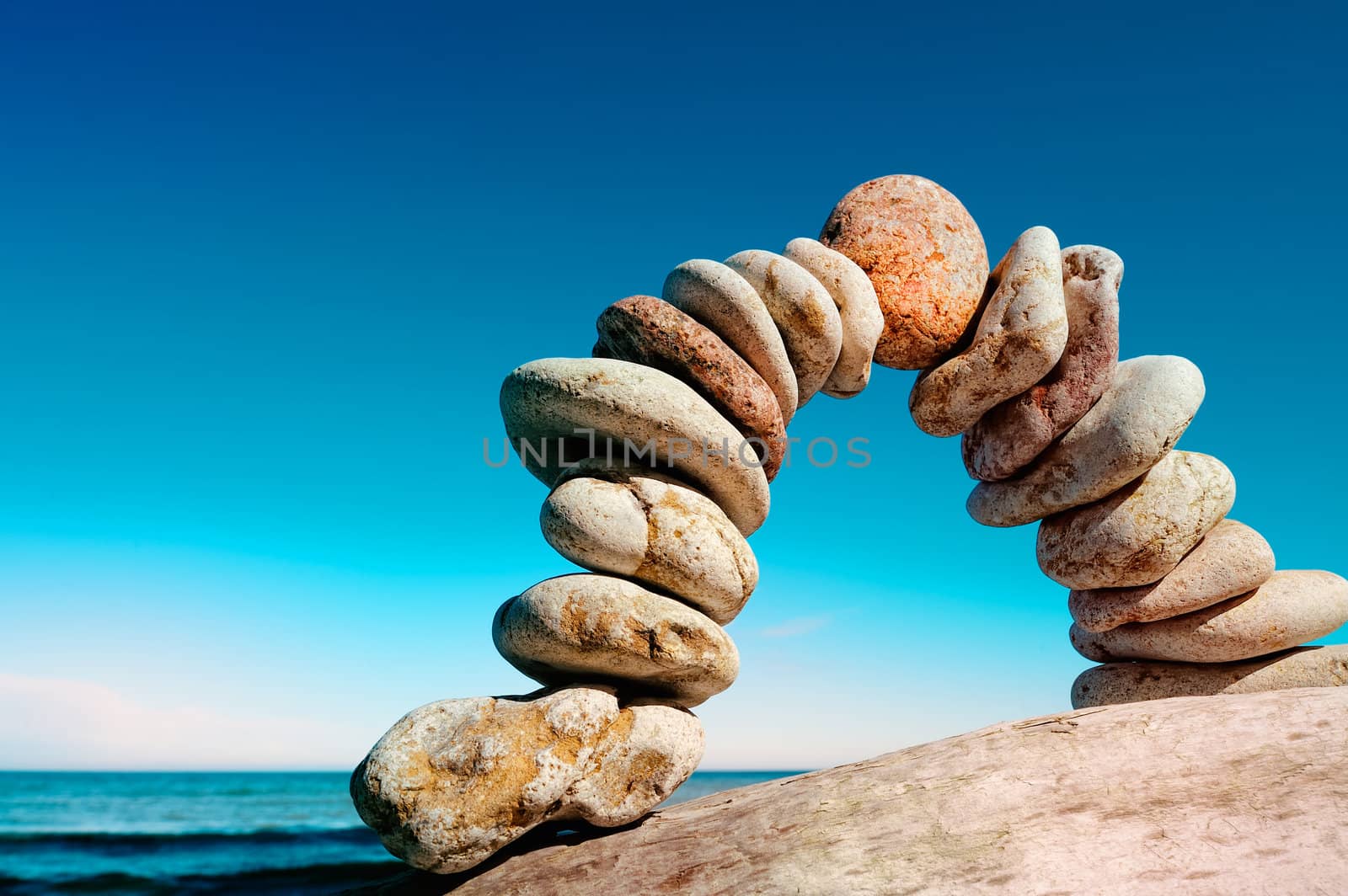 Curve of the pebbles on the sea coast