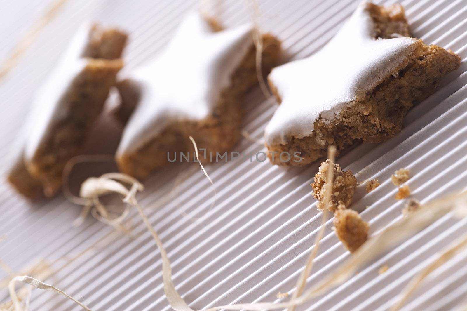 three glazed nut cookies on white background, close up