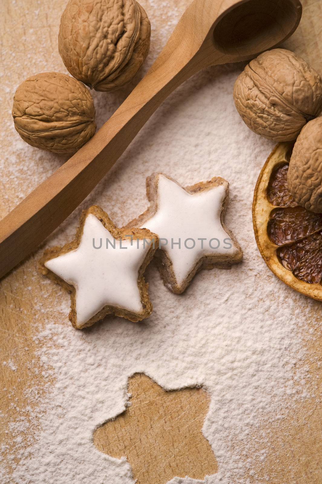 nuts and star shaped cookies on wooden board