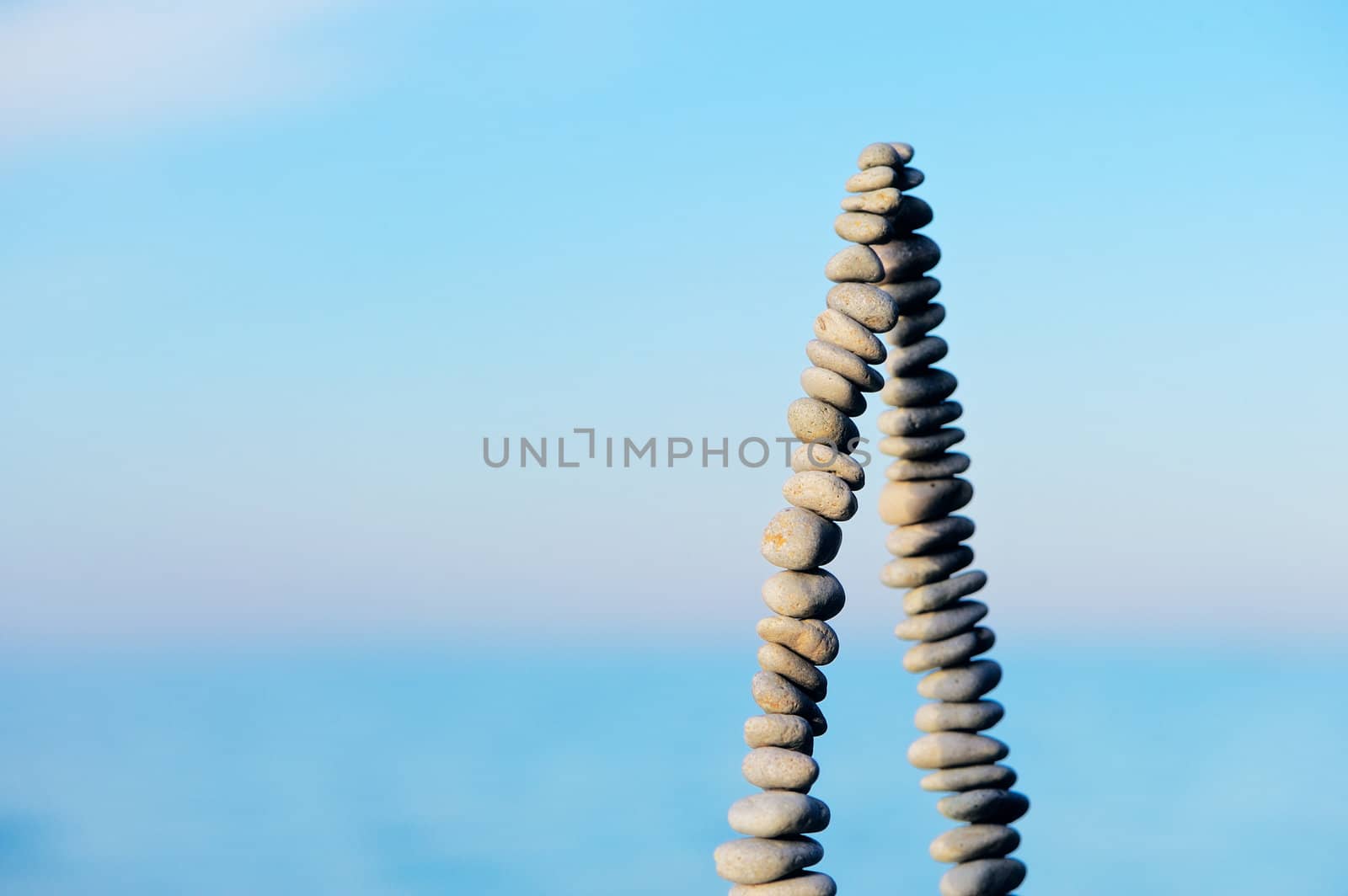 Pile of pebbles as pyramid against the background of sky