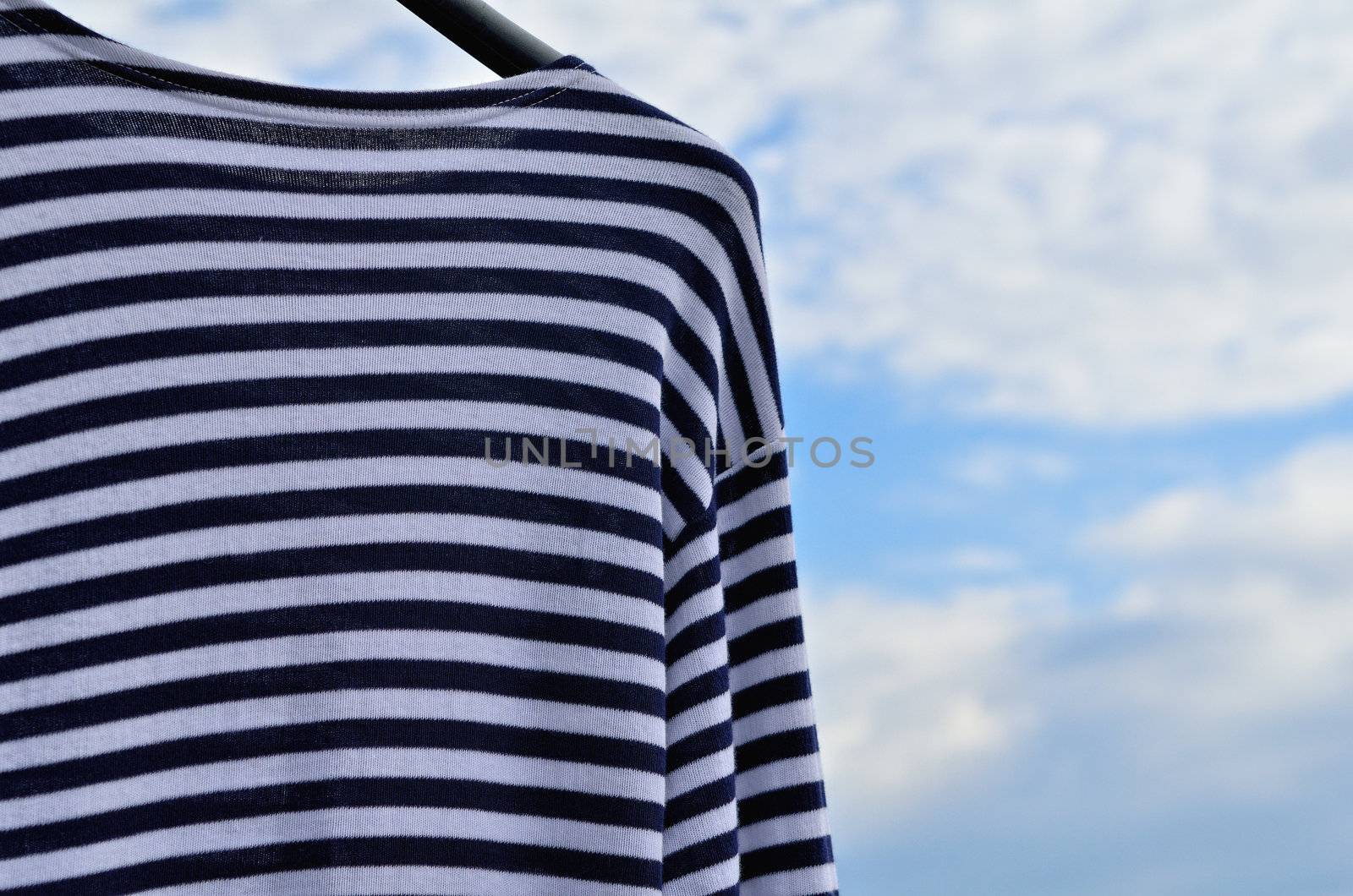 Blue striped vest against the blue sky