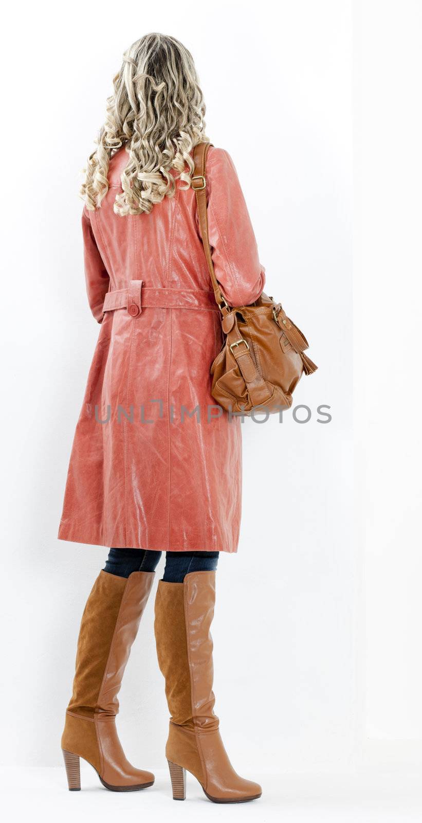 woman wearing fashionable brown boots with a handbag