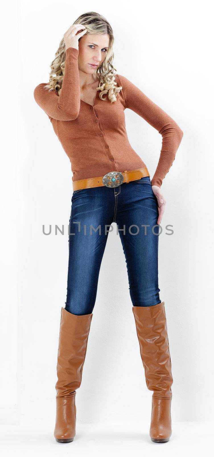 standing woman wearing fashionable brown boots by phbcz